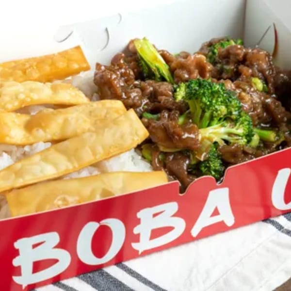 Boba Up's beef and broccoli with rice and crispy wontons in a takeout box.